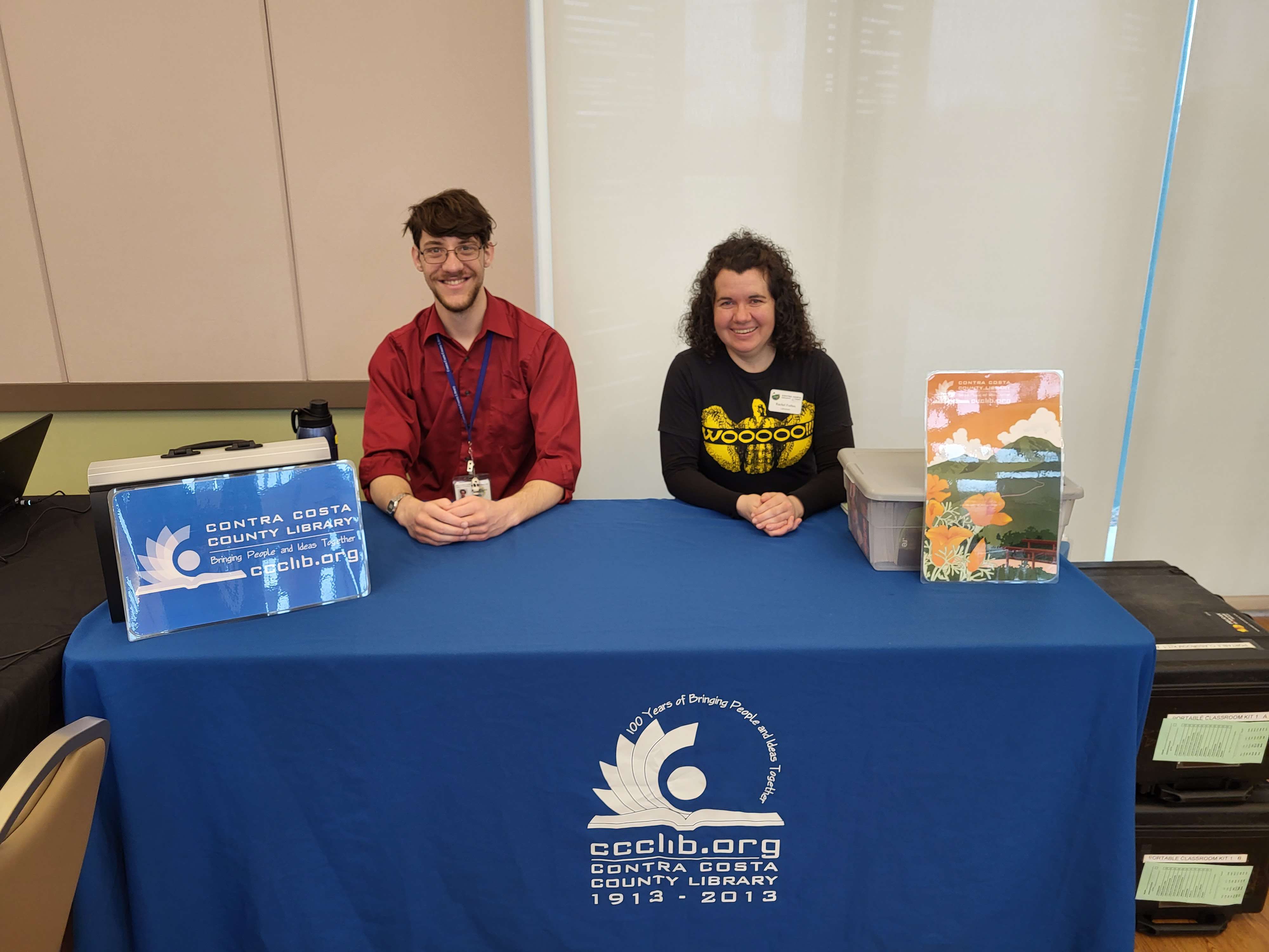 Mark conducting outreach with another library employee.