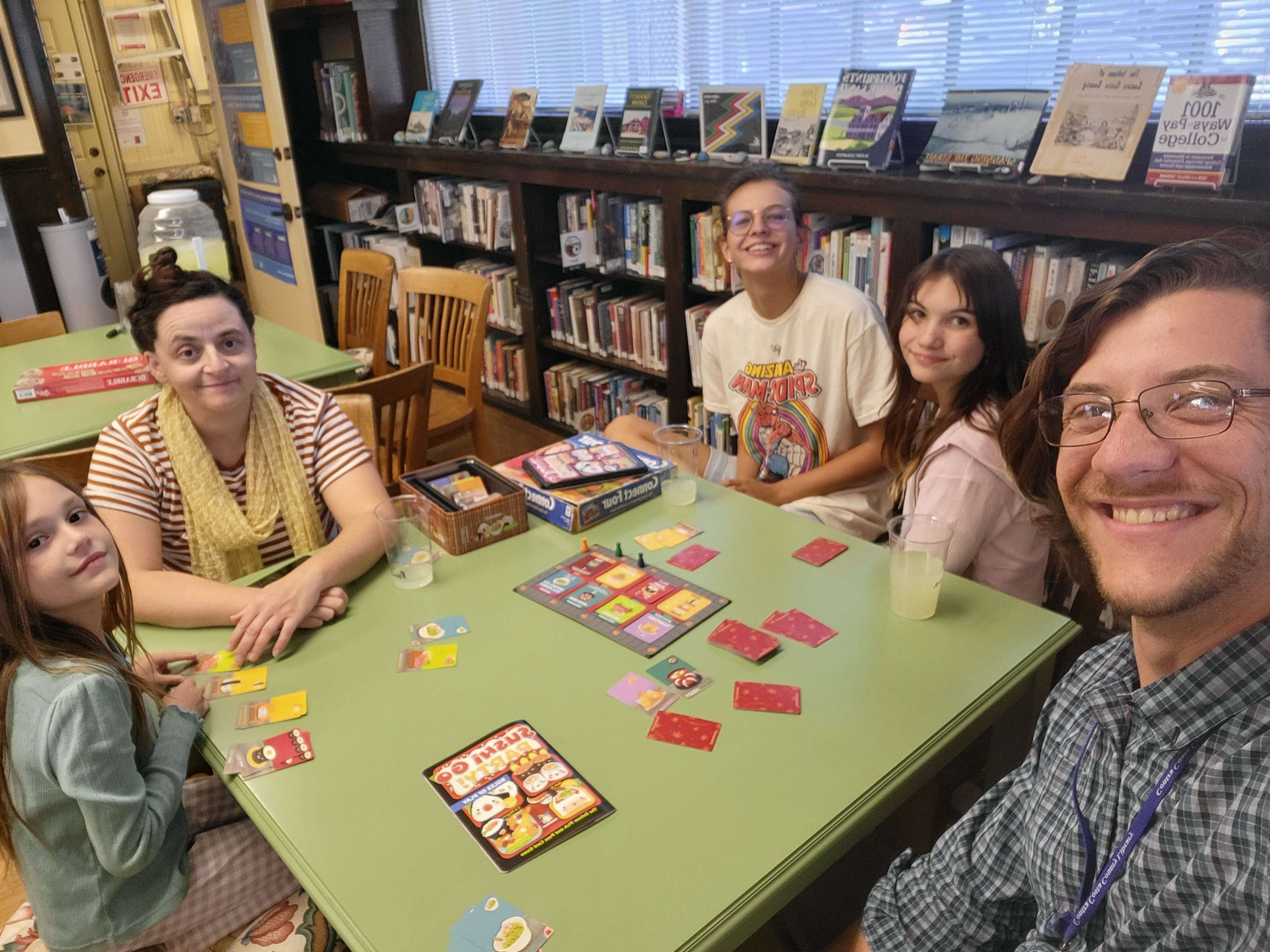 Mark playing board games with library patrons.