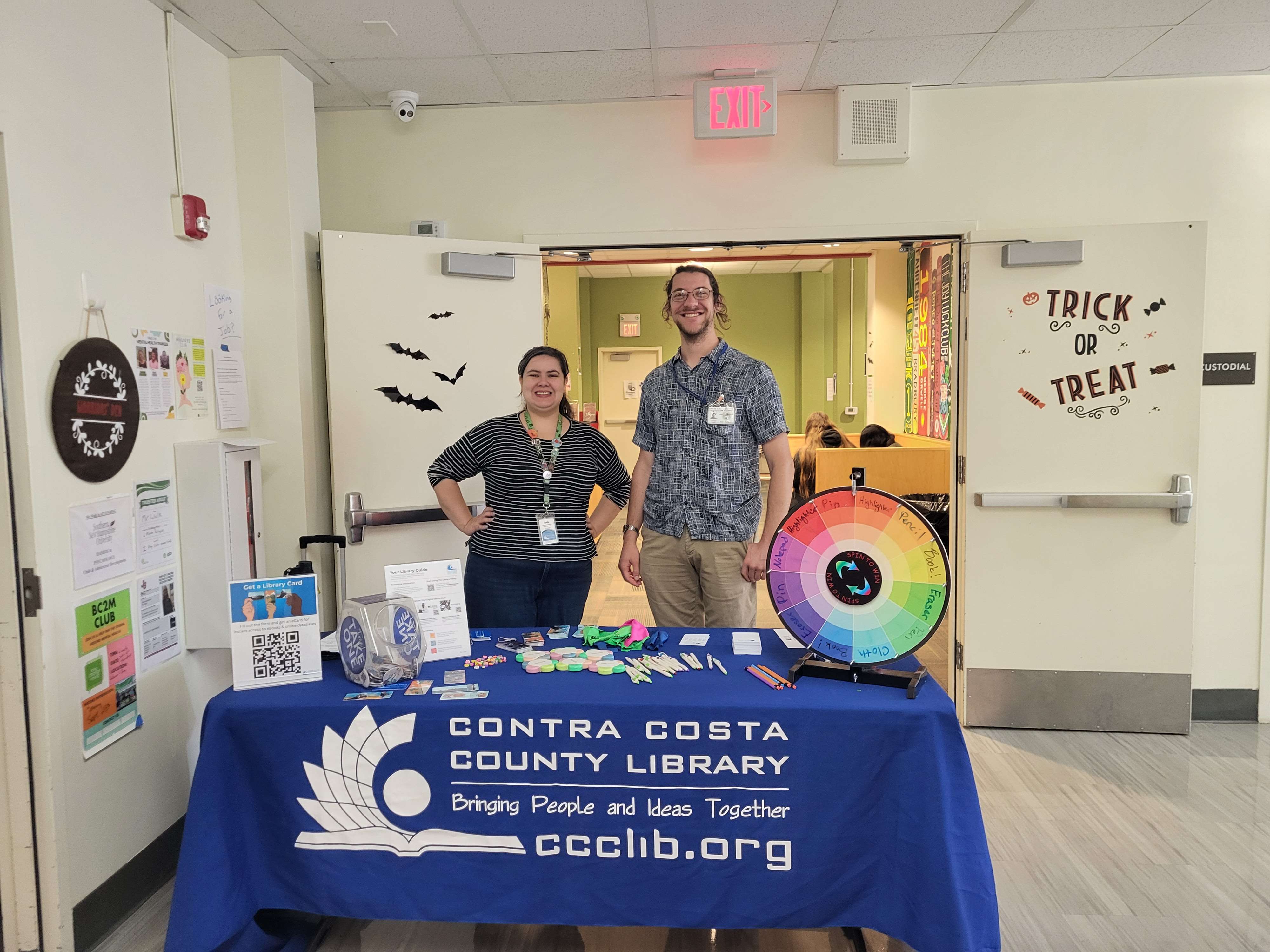 Mark conducting outreach with another library employee.